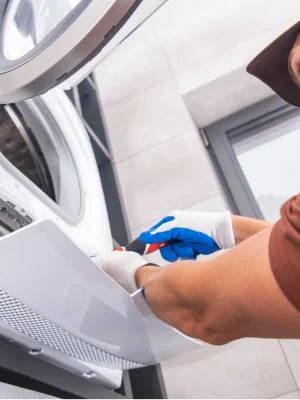 technician cleaning lint from dryer for better performance