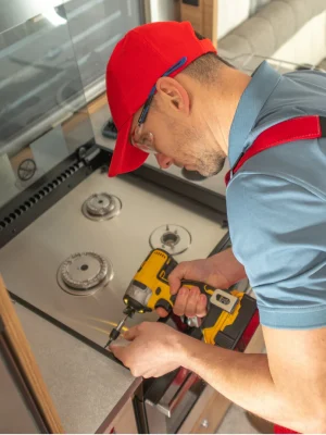 technician fixing kitchen stove for safe and efficient operation