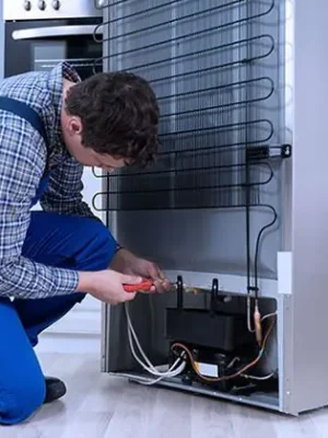 Technician repairing deep freezer cooling system and restoring functionality