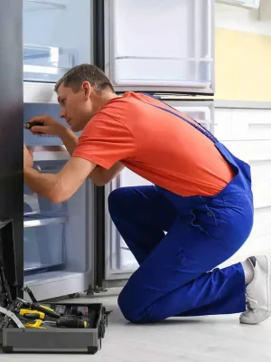 technician fixing deep freezer inside repair service maintenance