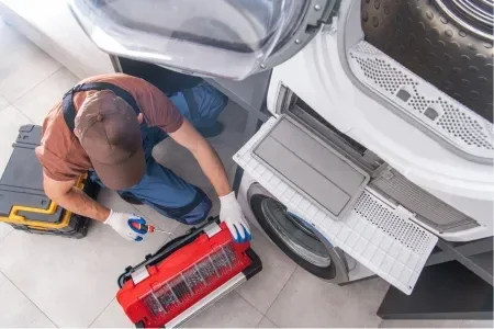 Technician repairing dryer
