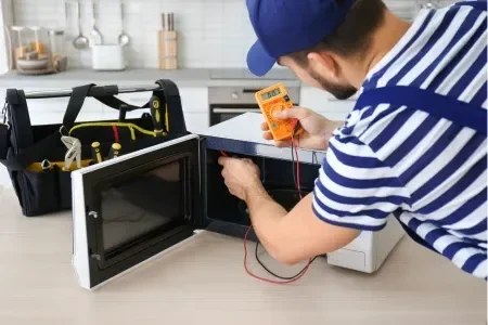 Technician repairing oven